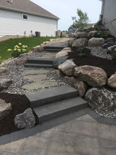 a stone walkway leading up to a house