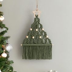 a green christmas tree hanging on the wall