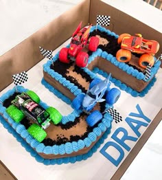 two birthday cakes in the shape of cars and trucks