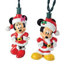 two mickey and minnie mouse christmas ornaments hanging from strings with lights on each ornament