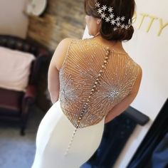 the back of a woman's dress with beading on it