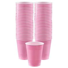 pink cups with white rims are stacked on top of each other in front of a white background