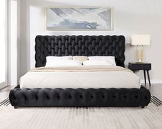 a large black bed sitting in a bedroom on top of a white carpeted floor