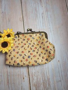 a small purse with a sunflower on it