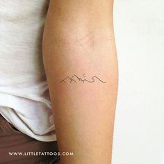 a woman's arm with a tattoo on it that says, mom in cursive writing