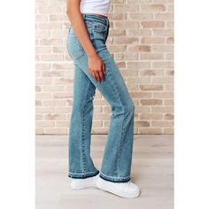 Our Isla Mid Rise Distressed Released Hem Bootcut Judy Blue Jeans! are the ultimate in comfort Figure flattering with a mid rise, while the released hem and bootcut add a touch of flair. The medium wash, distressed details and stretchy denim give them a lived-in, vintage feel. Upgrade your casual wear game with these must-have jeans available in regular, curvy and plus sizes until sold out! Ships in 3-5 business days. Material: 94% Cotton, 5% Polyester, 1% Spandex Fit: True to Judy Blue Sizing J Mid-rise Washed Blue Pants With Frayed Hem, Light Wash Relaxed Fit Flare Bottoms, Stretch Light Wash Pants With Frayed Hem, Light Wash Full Length Bottoms With Frayed Hem, Non-stretch Mid-rise Pants With Frayed Hem, Judy Blue Jeans, Blue Denim Shorts, Jogger Jeans, Cardigan Tops