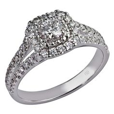 a diamond ring with two rows of diamonds on the band and an oval shaped center