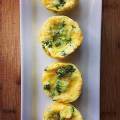 three muffins with broccoli and cheese on a white plate