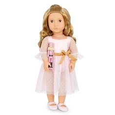 a doll with blonde hair wearing a pink dress and holding a nutcracker in her hand