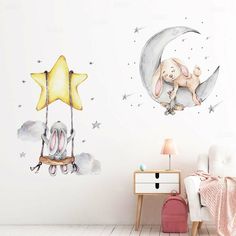 a child's room with an elephant on the moon and stars wall decals