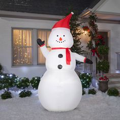 a large inflatable snowman with a red hat and scarf