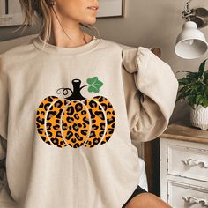 Crewneck Sweatshirt, Fall Sweatshirt, Pumpkin Crewneck Sweatshirt, Fall Pumpkin Shirt, Pumpkin Sweatshirt, Fall Time, Cheeta Print Pumpkin Introducing our latest must-have for the upcoming Fall season: the cozy and stylish Crewneck Sweatshirt. Embrace the crisp air and pumpkin spice vibes with our exquisite Fall Pumpkin Shirt. This Pumpkin Sweatshirt is the perfect embodiment of Fall Time charm, designed to keep you warm and fashionable as the leaves change. Crafted with the highest quality materials, this Fall Sweatshirt features a classic crewneck design that offers both comfort and a touch of elegance. The intricate Pumpkin design on the front captures the essence of autumn, making it a standout piece in your seasonal wardrobe. But that's not all - we've added a unique twist to this Fal Southwestern Fashion Boho, Summer Athleisure Outfits, Thankful Sweatshirt, Summer Athleisure, Disney Outfits Women, Mickey Sweatshirt, Sweatshirt Ideas, Disney Sweatshirt, Leopard Pumpkin