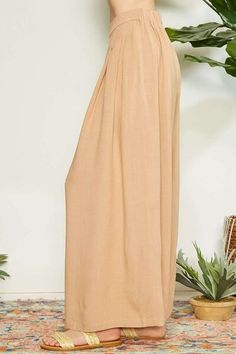 Introducing our fabulous Wrap Pleating Detail Wide Leg Pants. These pants are the epitome of modern elegance and sophistication. The wrap pleating detail adds texture and visual interest, while the wide leg silhouette provides a chic and flattering fit. Made with high-quality fabric, these pants are comfortable, breathable, and perfect for any occasion. Dress them up with a blouse and heels for a polished and refined look, or dress them down with a simple tee and sneakers for a more casual yet s Chic Beige Wide-leg Culottes, Spring Wide Leg Trousers With Pleated Waist, Pleated Wide Leg Pants For Summer, Pleated Wide-leg Pants For Summer, Wide Leg Pants With Pleated Waist, Chic Wide Leg Trousers, Summer Solid Pleated Wide Leg Pants, Pleated Solid Wide Leg Pants For Summer, Solid Pleated Wide Leg Pants For Summer