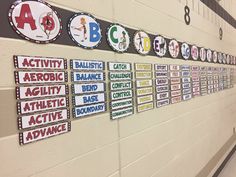 a hallway with signs on the wall and people walking down the hall in front of them