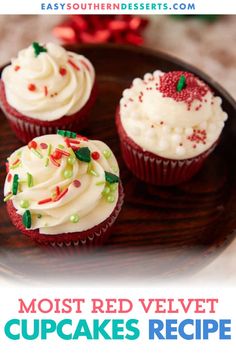 three red velvet cupcakes with white frosting and sprinkles on top