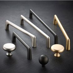 various handles and knobs on a black surface