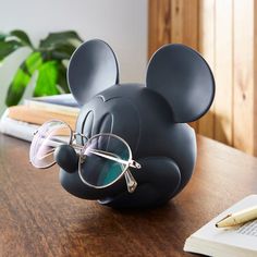 a mickey mouse with glasses on top of a desk