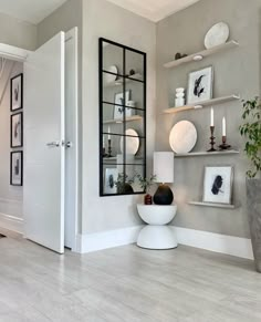 a living room filled with furniture and pictures on the wall