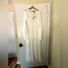 a white dress hanging up on a door