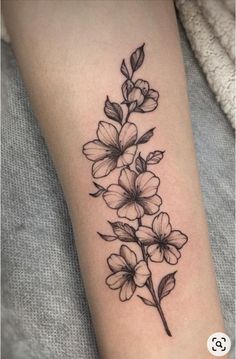 a black and white flower tattoo on the arm