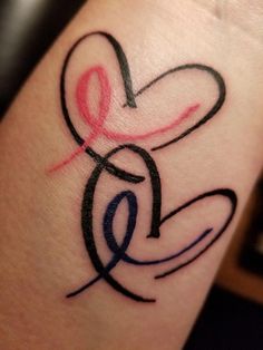 a tattoo on the arm of a woman with a heart and letter s in it