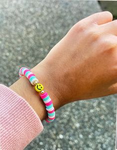 It's a preppy smiley pink and blue bracelet that's made with love. Casual Multicolor Bracelets For Everyday Wear, Casual Multicolor Bracelets For Everyday, Casual Letter Beads Friendship Bracelets For Spring, Trendy Multicolor Stretch Bracelet, Trendy Multicolor Friendship Bracelets, Trendy Multicolor Round Stretch Bracelet, Casual Blue Friendship Bracelets For Spring, Casual Multicolor Friendship Bracelets For Everyday, Casual Multicolor Everyday Friendship Bracelets