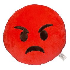 a red pillow with an angry face drawn on it