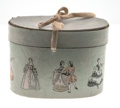 an old tin box with pictures of women on the front and sides, tied to a rope