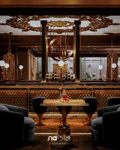 an elegant dining room with chandelier, chairs and table in front of the bar