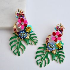 Tropical Statement Earrings Amazing Tropical Color Statement Earrings Perfect For The Summer #Vacationvibes Enamel Painted Leaves With Sequin Flowers. Light Weight For Their Size, Won’t Leave Your Lobes Sore. Also Available In Yellow! Tags: Earrings, Summer, Colorful, Statement, Big, Long, Party, Anthropologie, Bauble Bar Colorful Flower Earrings For Summer, Pink Spring Jewelry For Vacation, Pink Jewelry For Spring Vacation, Pink Spring Vacation Jewelry, Multicolor Flower Earrings For Summer Beach, Pink Dangle Jewelry For Vacation, Trendy Multicolor Earrings For Vacation, Fun Pink Earrings For Vacation, Pink Flower-shaped Jewelry For Vacation