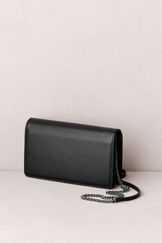 You'll always have your essentials at your fingertips with this large leather wallet purse, whether you're carrying it over your shoulder or holding it in your hands. Equipped with multiple slots and pockets to keep your cards, cash, and IDS safe and secure and a shoulder strap, this bag is ready to be worn for a night on the town or to be tossed in a tote for an easy weekend getaway. Leather Clutch Wallet, Clutch Wallet, Leather Clutch, Metal Chain, Chain Strap, Purse Wallet, Leather Wallet, Shoulder Strap, Wallet