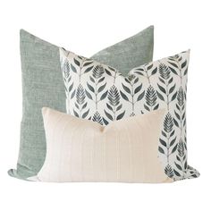 three pillows in various colors and patterns on a white background, each with a decorative leaf design