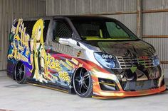 a van painted with graffiti is parked in a garage