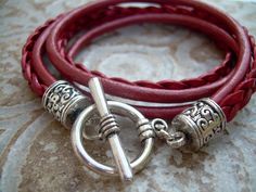 A Metallic Red Leather Bracelet.... Super stylish and feminine, wrap this twice around your wrist, toggle up and off you go. This Double Wrap Leather Bracelet features 3mm round, 3mm braided and 5mm flat braided metallic leather cords. Lead and Nickel Free - Aged Silver Toned Alloy Components, Secure Toggle Closure for Easy on and off. All dyes used in our leather are certified 100% Lead-Free and meet all requirements of the German Goods Ordinance, REACH (European Union), RoSH (U.K.), and CPSIA Trendy Red Adjustable Leather Bracelet, Adjustable Burgundy Bracelets, Handmade Red Wrap Bracelet, Red Leather Bracelet, Leather Bracelets Women, Womens Bracelet, Bracelet Leather, Toggle Bracelet, Womens Jewelry