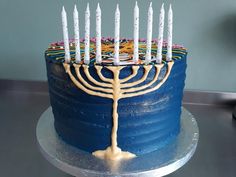 a blue cake with white candles on it