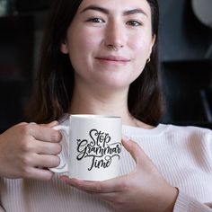 a woman holding a coffee mug with the words stop glamour time on it in black ink