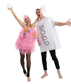 two people dressed in costumes are posing for the camera and one is holding an egg carton