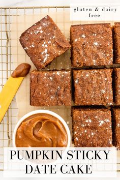 pumpkin sticky date cake on a cooling rack with a knife and bowl of peanut butter