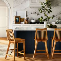 two wooden chairs sitting next to each other in a kitchen