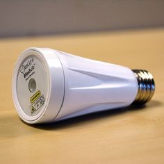 an electric toothbrush on a wooden surface with the light turned on and nozzles