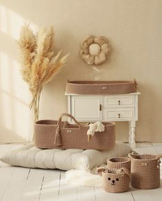 a baby crib with several baskets on the floor