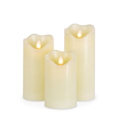 three lit candles sitting next to each other