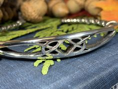 TAKE AN ADDITIONAL 20% OFF THE ALREADY REDUCED SALE PRICE - ADDITIONAL 20% IS DEDUCTED AT CHECKOUT with code SAVE20 Stunning! Our lead & nickle free Pewter Celtic Knot Bangle Bracelet features an ancient Celtic weave design that goes back thousands of years, embraced on both sides by a Celtic knot work pattern. Made of heavy, solid pewter that will never tarnish and designed to last a lifetime. A beautiful gift! Bracelet is in the cuff style with an open back and can be adjusted for almost a Celtic Jewelry Fantasy Forge Jewelry, Leather Celtic Knot, Irish Jewelry Celtic Designs, Celtic Leather Bracelet, Celtic Jewellery Ancient, Celtic Knot Work, Celtic Knot Bracelet, Celtic Weave, Knot Bangle