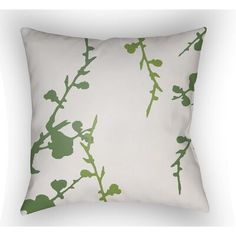 a white pillow with green leaves on it