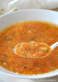 a white bowl filled with soup and a spoon