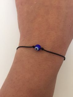 "BUY TWO GET A THIRD FOR FREE!! (please, don't add your free product to your shopping cart or you will be charged for it. Pick 1 product and leave the full name of it in the \"Note to enjoywelrydesign\" Box during checkout.)This is a black nylon cord bracelet with a crystal evil eye. Wear this bracelet to protect yourself. The evil eye is a curse believed to be cast by a malevolent glare, usually given to a person when they are unaware. Talismans created to protect against the evil eye. The brac Adjustable Evil Eye Bracelet For Friendship, Trendy Adjustable Evil Eye Friendship Bracelets, Adjustable Evil Eye Bracelet With Sliding Knot, Adjustable Spiritual Evil Eye Bracelet With Sliding Knot, Handmade Casual Evil Eye Bracelet, Casual Evil Eye Bracelets, Trendy Evil Eye Jewelry, Adjustable Evil Eye Bracelet For Everyday, Black Adjustable Evil Eye Bracelet