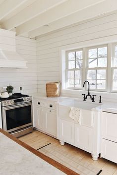 a kitchen with an oven, sink and dishwasher in the middle of it