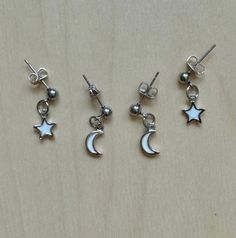 This is sold as a set. Earring set includes 1 pair of moon earrings and 1 pair of star earrings. Dainty White Earrings With Star Charm, Celestial White Sterling Silver Earrings, White Sterling Silver Celestial Earrings, White Sterling Silver Earrings With Star Charm, White Celestial Star Earrings, Celestial White Star Earrings, White Dangle Cartilage Earrings, White Star Charm Earrings As Gift, White Star-shaped Earrings With Star Charm