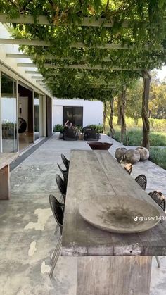 a long wooden table sitting on top of a patio