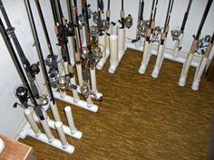 there are many different types of fishing rods in this room, all lined up on the wall